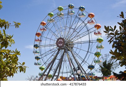 Attraction colorful ferris wheel on the background of bright blue sky - Powered by Shutterstock