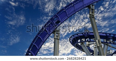 Attraction roller-coaster (switchback) on the background of the cloudy sky 
