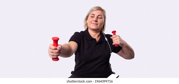 Attractive 50 Year Old Woman Doing Fitness, Isolated On Gray Background. High Quality Photo