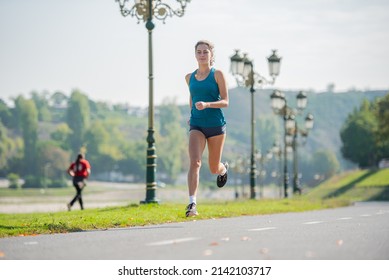Attractive adn beautiful fit girl is smiling and running before her training