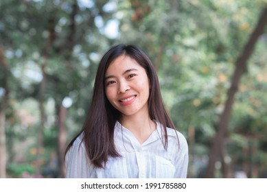 Attractive Adult Business Woman Asian Girl With Happy And Smile Standing On Walk Way Go To Working Between Her Office On Morning Under Green Forest.