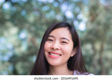 Attractive Adult Business Woman Asian Girl With Happy And Smile Standing On Walk Way Go To Working Between Her Office On Morning Under Green Forest.