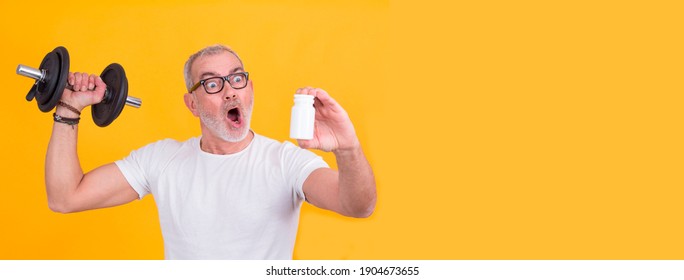 Attractive Adult Man Doing Sports With Dumbbells And In Hand With Vitamin Bottle Or Food Supplement