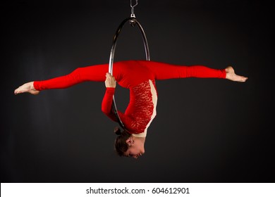 Attractive aerialist woman exercising on aerial ring (lyra) - Powered by Shutterstock