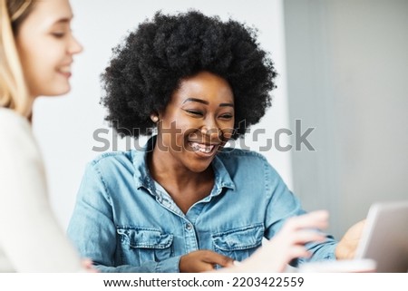 Attractive african american business woman in a modern office or a student in a classroom