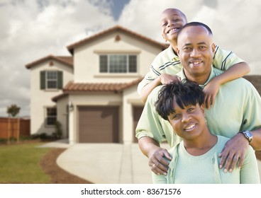 Attractive African American Family in Front of Beautiful House.