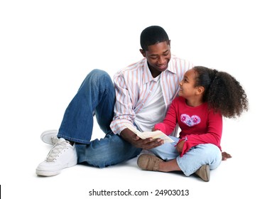 Attractive African American Father And Daughter Reading Together.