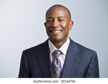 Attractive African American headshot dressed in a suit and tie, facing the camera. Square.