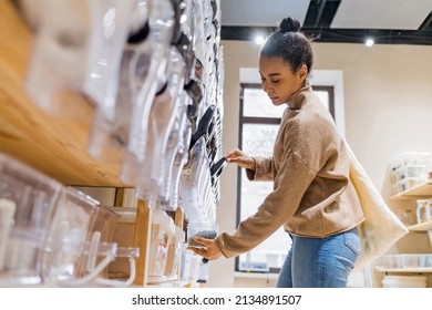 Attractive african american woman buying cereals and grains in sustainable grocery store