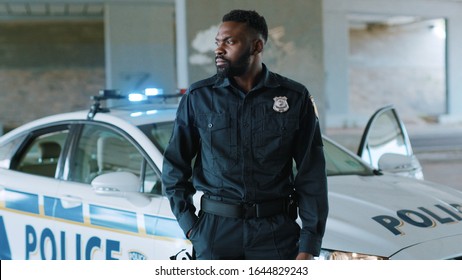 Attractive African American Young Man Cops Stand Near Patrol Car Look At Camera Enforcement Happy Officer Police Uniform Auto Safety Security Communication Control Policeman Close Up Slow Motion