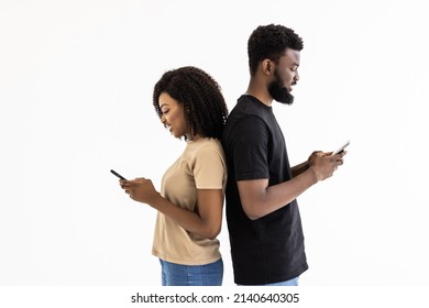 Attractive African Ethnicity Couple Hold Smart Phones Having Fun In Internet