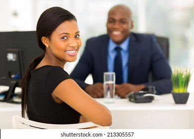 attractive african office worker looking back