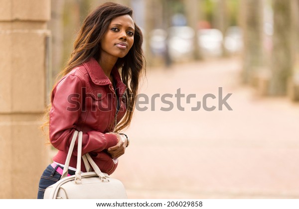 attractive african woman\
waiting for a taxi