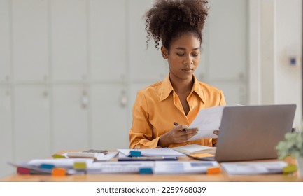 Attractive african young confident businesswoman Accounting using calculating income-expenditure and analyzing real estate investment data report Financial and tax systems concept. - Shutterstock ID 2259968039
