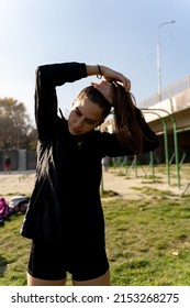 Attractive And Amazing Fit Girl Is Fixing Her Hairwhile Wearing All Black Clothes