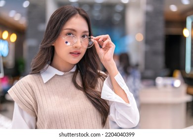 Attractive Asia Young Adult Female Woman Casual Cloth Spending Weekend Vacation Enjoy Choosing Glasses In Optical Store Shop She Is Pick The Favourite One For Herself