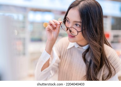 Attractive Asia Young Adult Female Woman Casual Cloth Spending Weekend Vacation Enjoy Choosing Glasses In Optical Store Shop She Is Pick The Favourite One For Herself