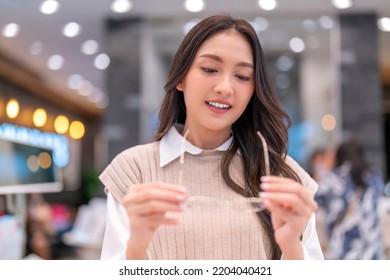 Attractive Asia Young Adult Female Woman Casual Cloth Spending Weekend Vacation Enjoy Choosing Glasses In Optical Store Shop She Is Pick The Favourite One For Herself