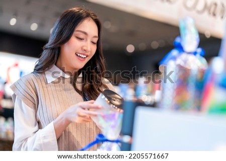 Attractive asian Beautiful female woman with shopping bags are choosing cosmetics and smiling while doing shopping store in the department  store shopping mall casual lifestyle