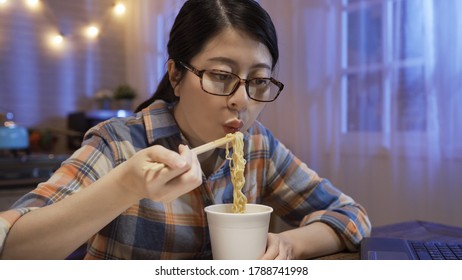 Attractive Asian Chinese Young Woman Enjoying Fast Food Ramen Soup During Bedtime Snack Break.