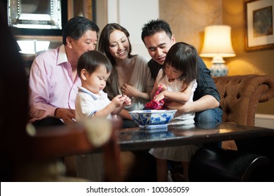 Attractive Asian Family In Lounge