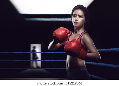 Attractive Asian Female Boxer In Boxing Arena While Training