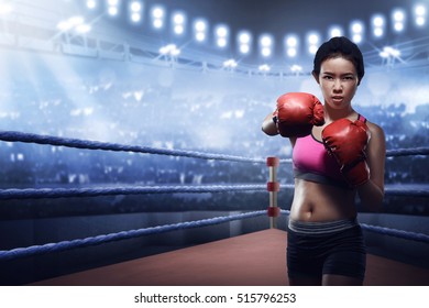 Attractive Asian Female Boxer In Boxing Arena While Training