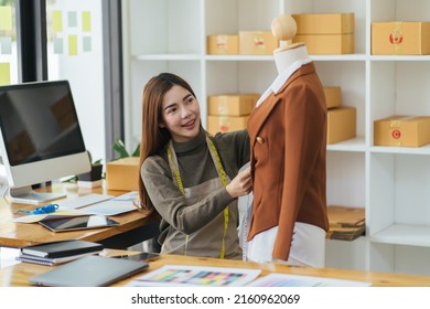 Attractive Asian Female Fashion Designer Working In Home Office Workshop. Stylish Fashionista Women Creating New Cloth Design Collection. Tailor And Sewing. People Lifestyle And Occupation Concept.