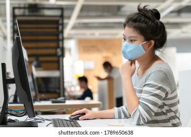 Attractive Asian Female Sweater Working While Wearing Protective Virus Mask Working In Co Woking Space That Have Plastic Partition Social Distancing For Seat New Normal Lifestyle