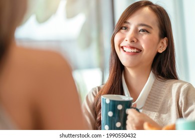 Attractive Asian Female Talking Good Positive Conversation To Friends With Smiling Laugh And Happiness Moment At Counter Near Window At Cafe With Daylight From Garden Positive Attitude Relationship