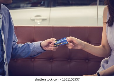 Attractive Asian Girl Millenials Buying A New Car With Credit Card. Film Effected. Close-up Scene