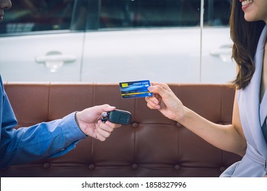 Attractive Asian Girl Millenials Buying A New Car With Credit Card. Film Effected. Close-up Scene