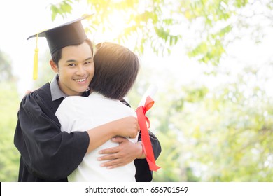 Attractive Asian Graduate Man In Cap And Gown Hugs Celebrating With Parent Feeling So Proud And Happiness In Graduation Day,Education Success Concept