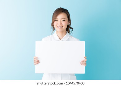 Attractive Asian Nurse  Holding Blank White Board