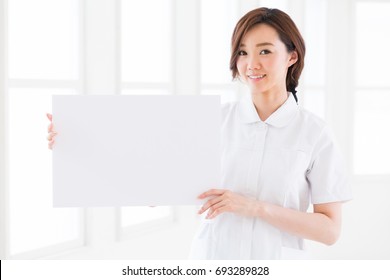 Attractive Asian Nurse  Holding Blank White Board