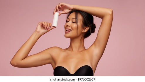 Attractive asian woman advertising for new cosmetic product. Female model promoting new skin care product. - Shutterstock ID 1976002637