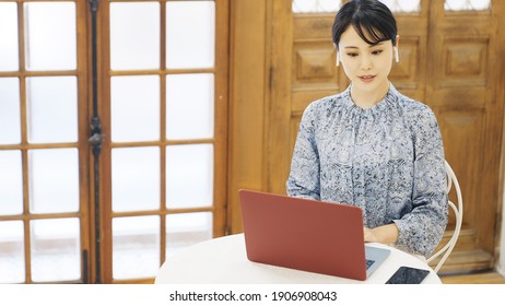 Attractive Asian Woman Calling With Video Phone. Remote Work. Video Conferencing.