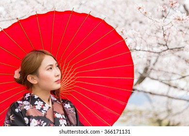 attractive asian woman and cherry tree in a kimono