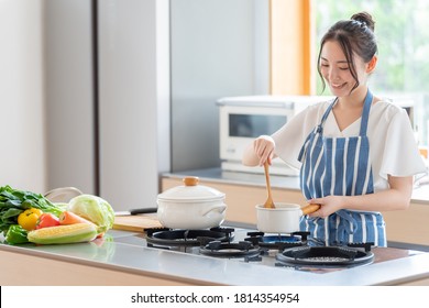 Attractive Asian Woman Cooking At Kitchen