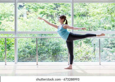 attractive asian woman doing ballet dance in studio