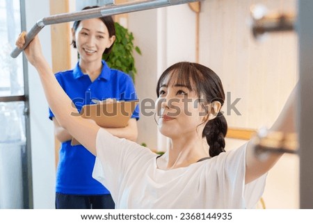 Similar – Image, Stock Photo A female trainer teaching a student how to do push-ups correctly.Outdoor sports in urban environment