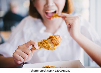 Attractive Asian Woman Eating Fried Chicken.