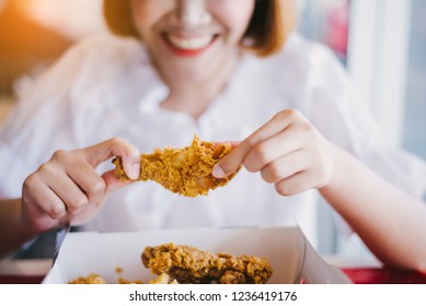 Attractive Asian Woman Eating Fried Chicken.