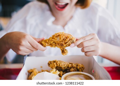 Attractive Asian Woman Eating Fried Chicken.