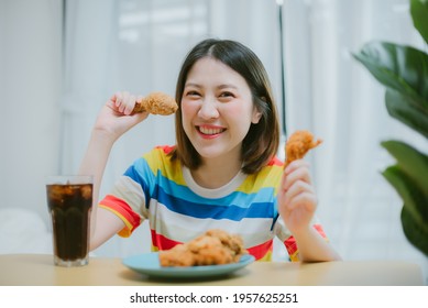 Attractive Asian Woman Eating Fried Chicken.