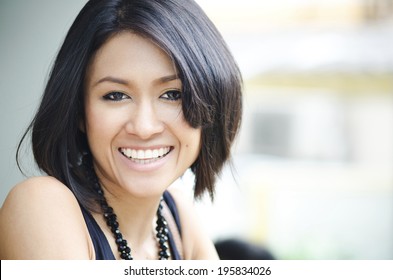 Attractive Asian Woman enjoys her drink