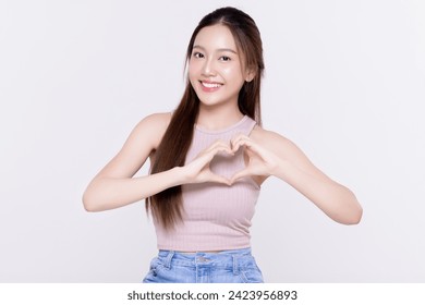 Attractive Asian woman feels happy and maks romantic hand sign heart shape isolated on white background. People affection and care concept - Powered by Shutterstock