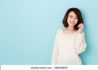 Attractive Asian Woman Isolated On Blue Background