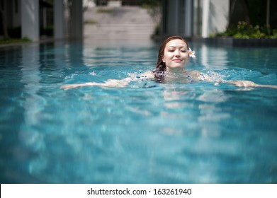 Attractive Asian Woman In Pool Swimming 