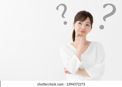 Attractive Asian Woman With Question Mark On White Background